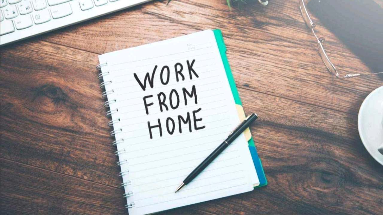 Indian woman working from home using laptop and smartphone